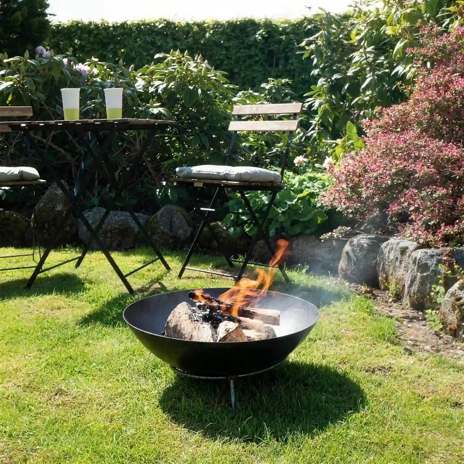 Oklahoma Firepit lit in a garden setting
