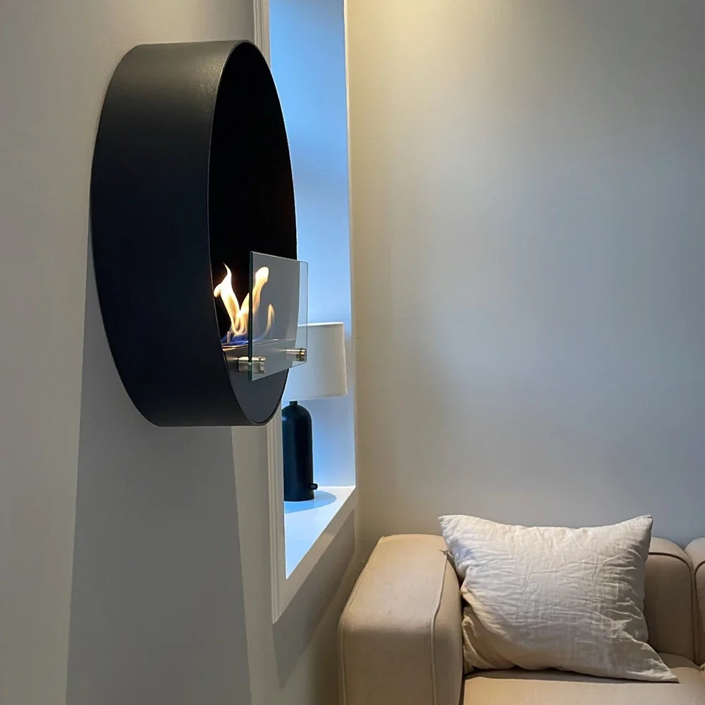 Delaware S black round bio fireplace, opposite angle of the window nook living room, lit with a realistic flame